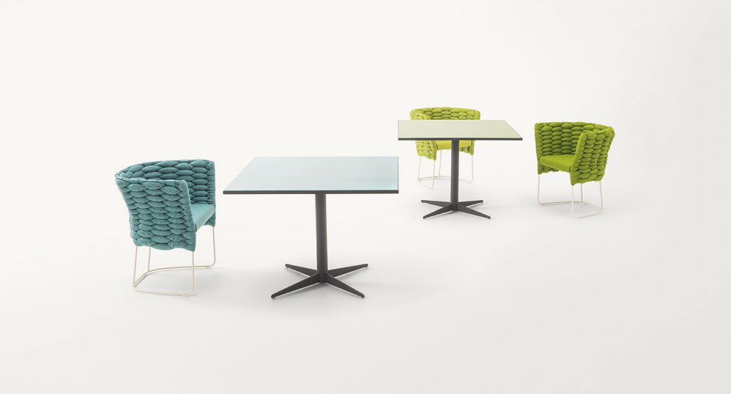 Two Cafe square tables, top one in blue and one in green and black steel central leg with four spokes on a white background.