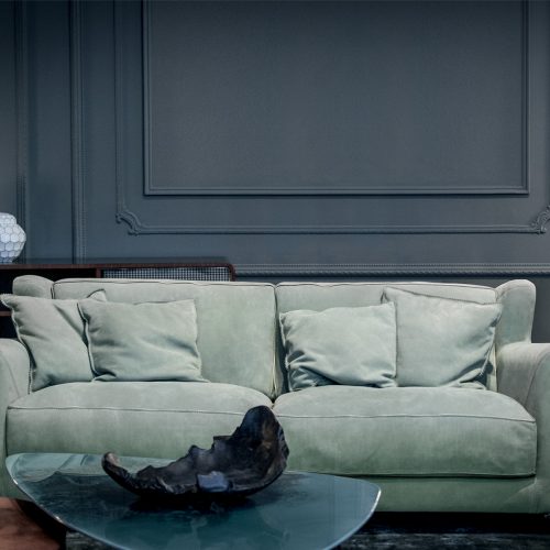 Bergère Longe Sofa. Single-part frame. Green Seat cushions and back cushions leather in a living room.