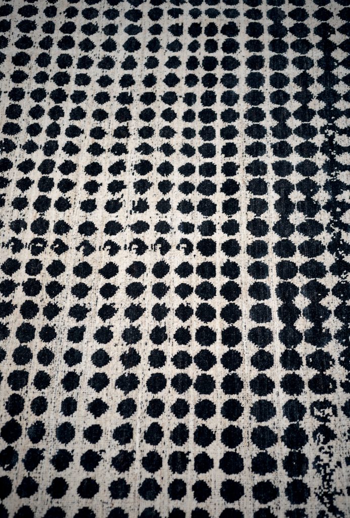 A Scarlet Pois rug, made of wools, hand-dyed in white and black circles pattern.