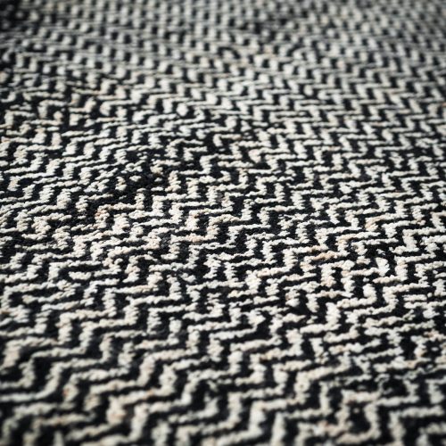 A Scarlet Twill rug, made of wools, hand-dyed in white and black zig zag pattern.