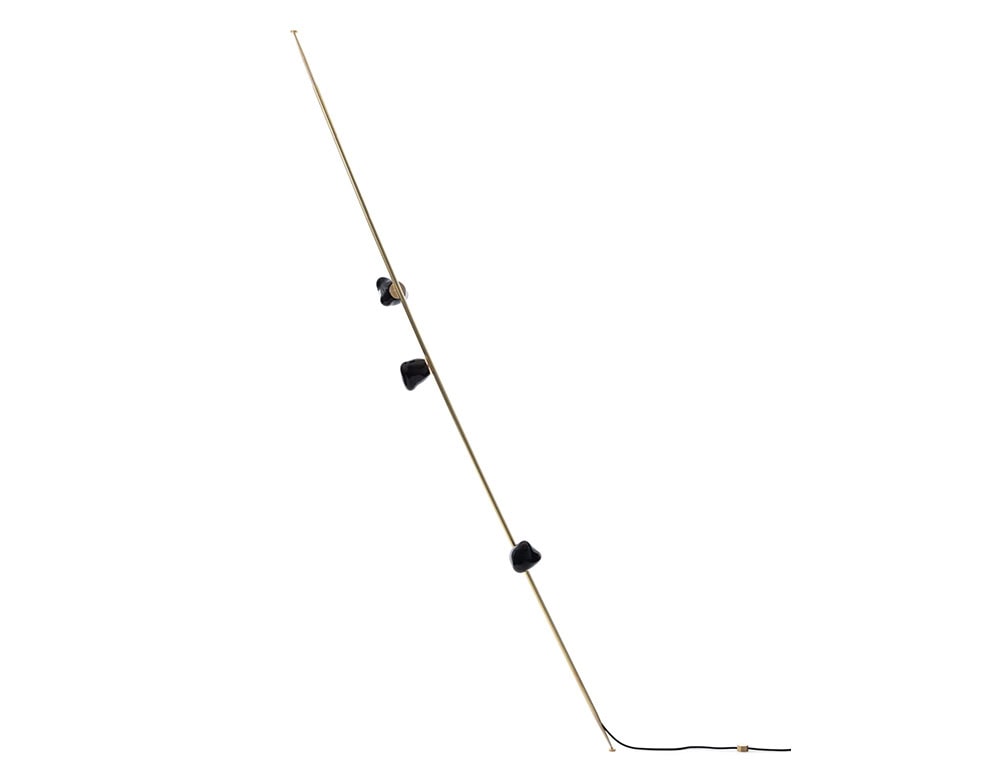 Boc Stem Column Floor Light features a brushed brass stem paired with black sculptural glass shades. The sleek contrast and slim profile create a visually dynamic floor lamp suited for elegant and modern spaces.