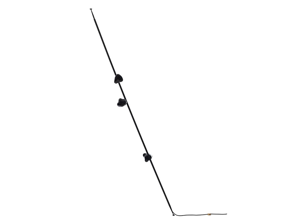 Boc Stem Column Floor Light in a matte black finish exudes a bold and refined aesthetic. The asymmetrical black glass shades offer diffused light and striking contrast, perfect for contemporary interiors.