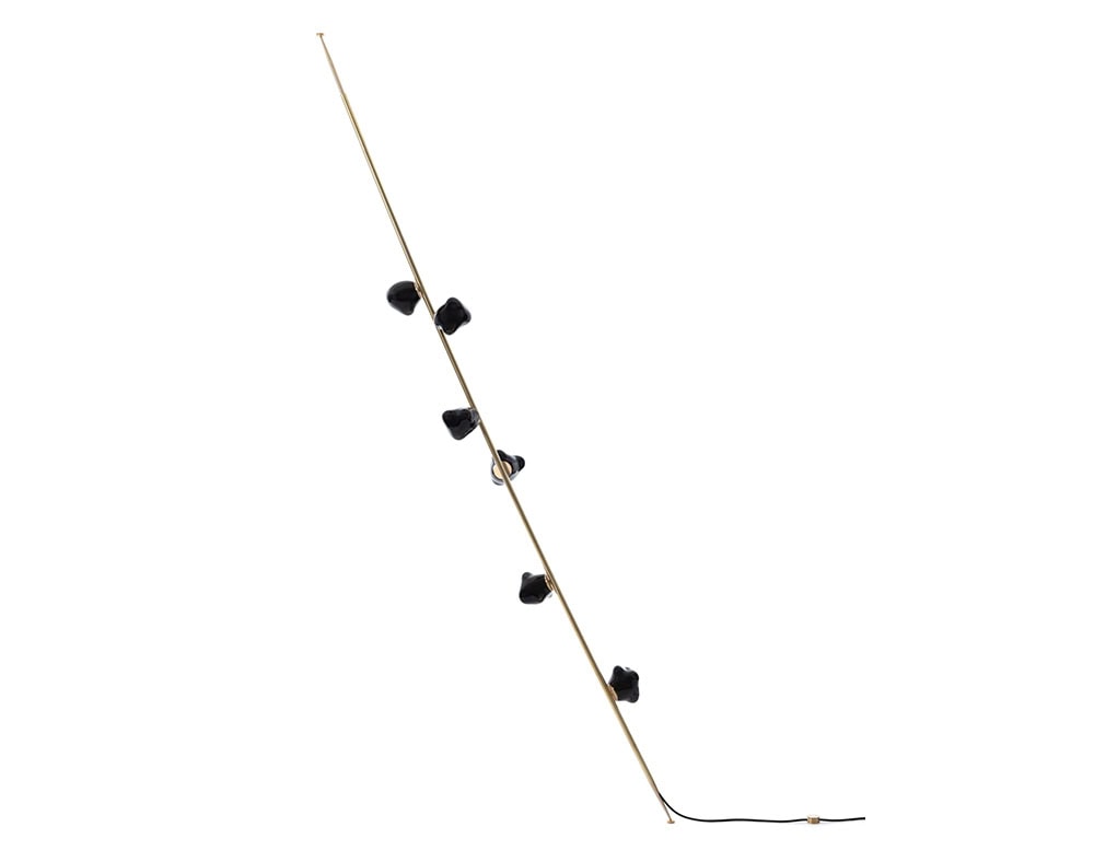 Boc Stem Column Floor Light features a slim, brass-finished stem paired with six deep black sculptural glass shades. Its minimal, vertical form creates an elegant presence in clean, contemporary spaces.