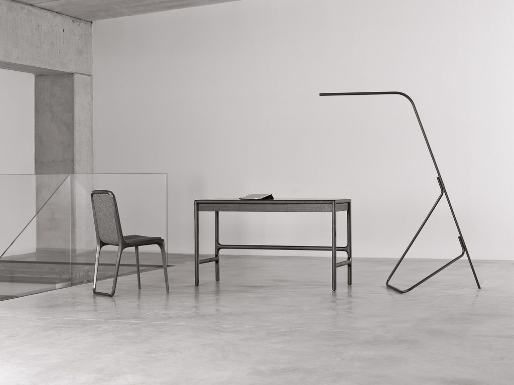 slim lamp made of brass in a black and white color tone in a living room