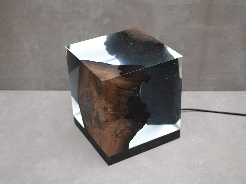 lamp made from natural wood and covered in resin throughout its structure, color according to the design