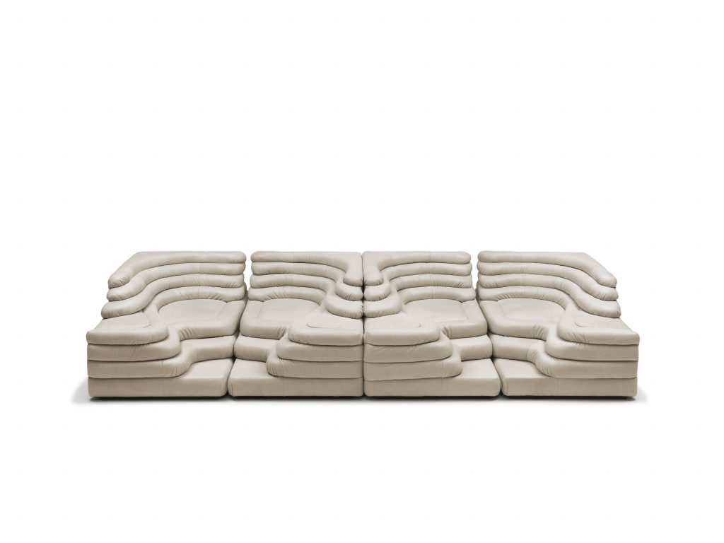 Four white cream DS Thousand twenty five sofa elements. The single element is a terraced hill with widths and depths that vary in tapering steps on a white background.