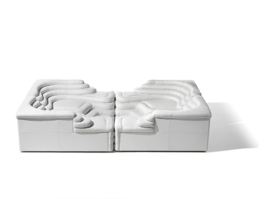 Two white DS Thousand twenty five sofa elements. The single element is a terraced hill with widths and depths that vary in tapering steps on a white background.