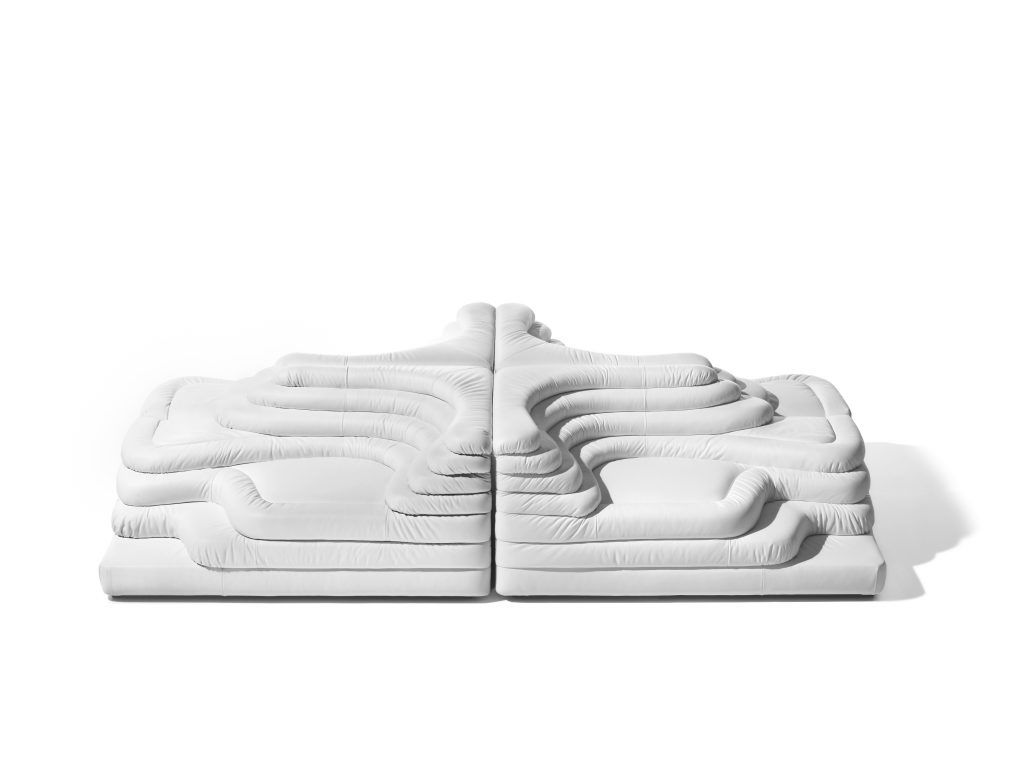 Two white DS Thousand twenty five sofa elements. The single element is a terraced hill with widths and depths that vary in tapering steps on a white background.