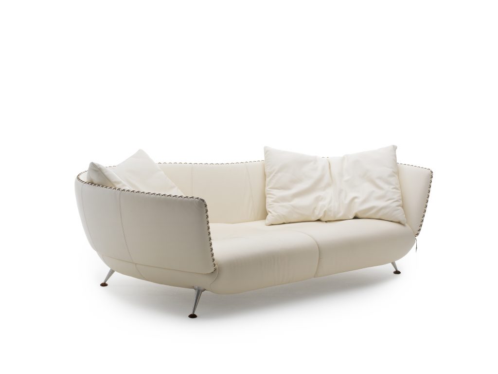 DS hundred two- twenty nine sofa with four legs. White and black upholstered shell on a white background.