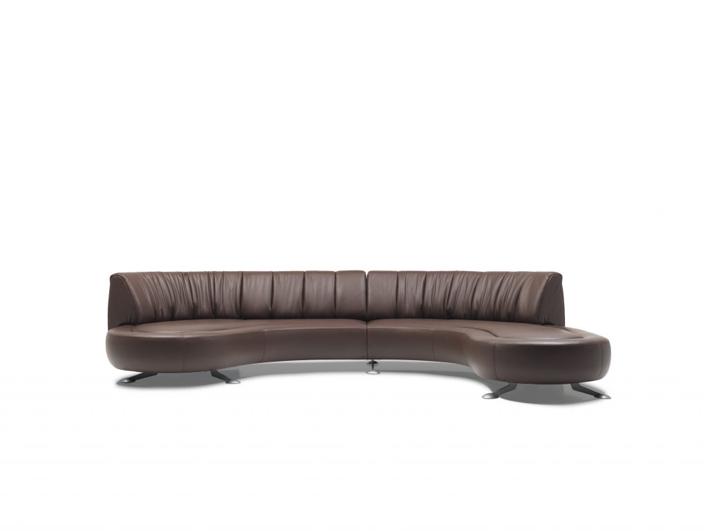 A brown DS-thousand sixty four sofa. rounded seat with backrest, cover in leather and steel legs on a white background.
