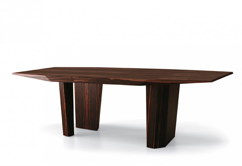 table characterized by the facets on the top made on a wood base flamed on a white background