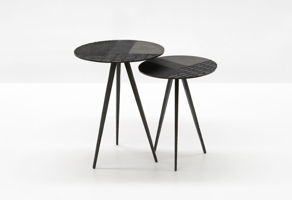 two coffee tables with surfaces decorated on a wooden base and textures in a black color tone on a white background