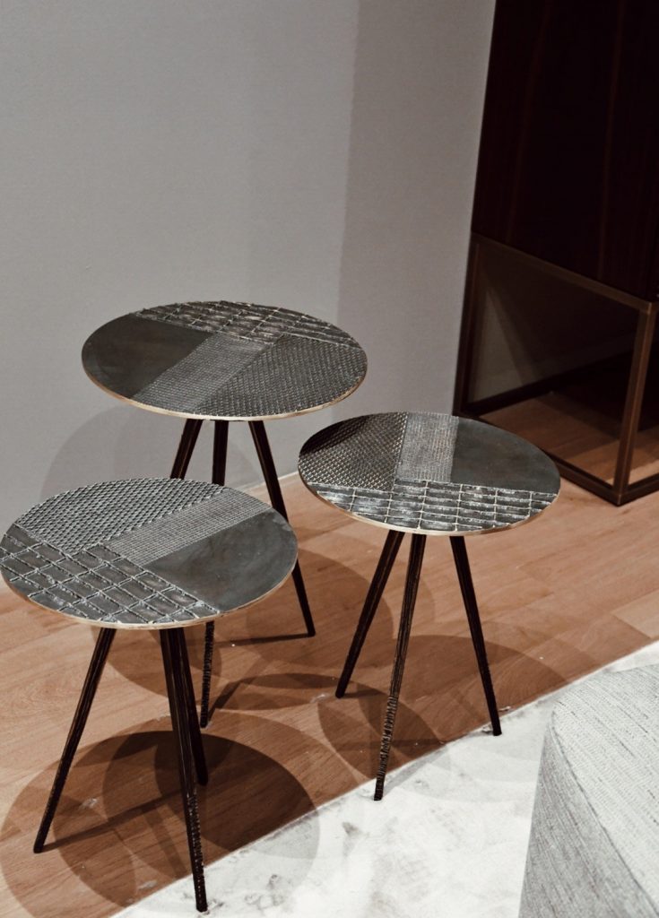 three coffee tables with surfaces decorated on a wooden base and textures in a black color tone