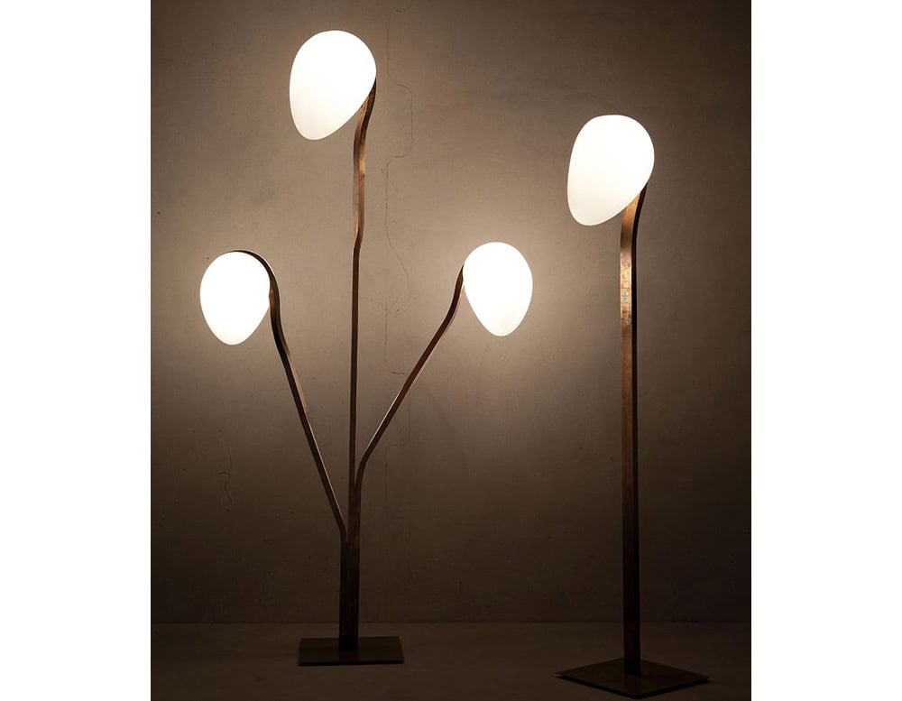 Two 10th Tree Light Outdoor Floor Lights with white, orb-shaped diffusers on slender stems are shown against a blurred background, with one light having multiple diffusers on a branching stem