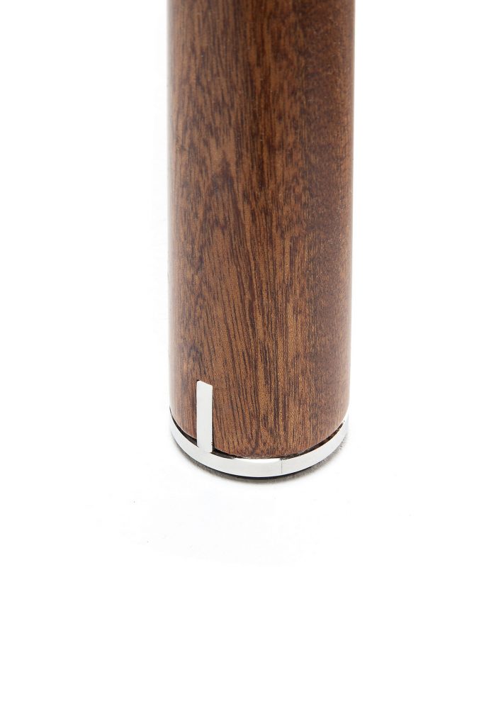 Closeup of Vieste Pouf brown leg on a white background.