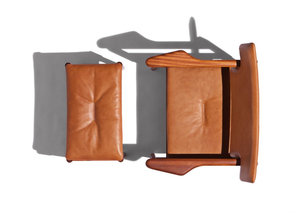 Vieste Pouf: Rectangular pouf with a brown cushioned top and four brown legs on a white background.