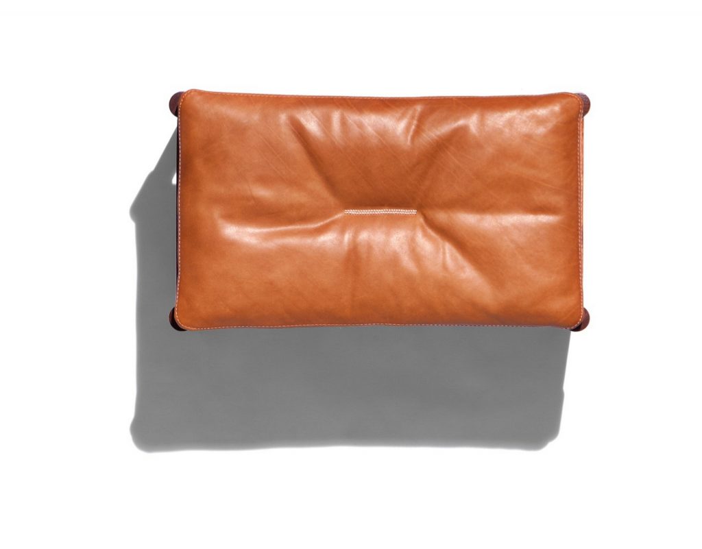Vieste Pouf: Rectangular pouf with a brown cushioned top and four brown legs on a white background.