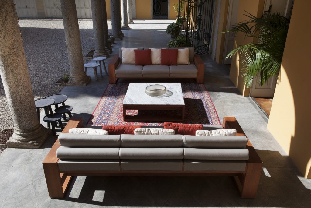 Bellagio Coffee Table: Rectangular top in white and gray marble with a brown base in a living room.