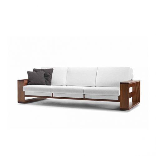 A Bellagio Outdoor Sofa with a wooden frame and white cushions is shown against a white background, with two dark pillows on one side, and a portion of the other side of the sofa visible