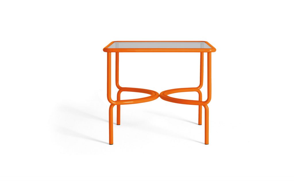 locus solus dining table in orange on a white background