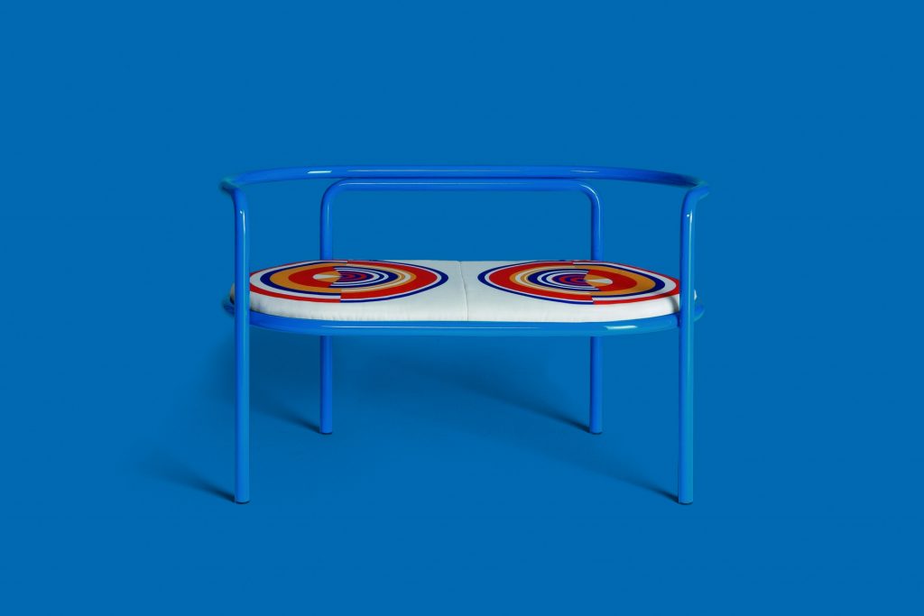 locus solus loveseat in blue with a blue background
