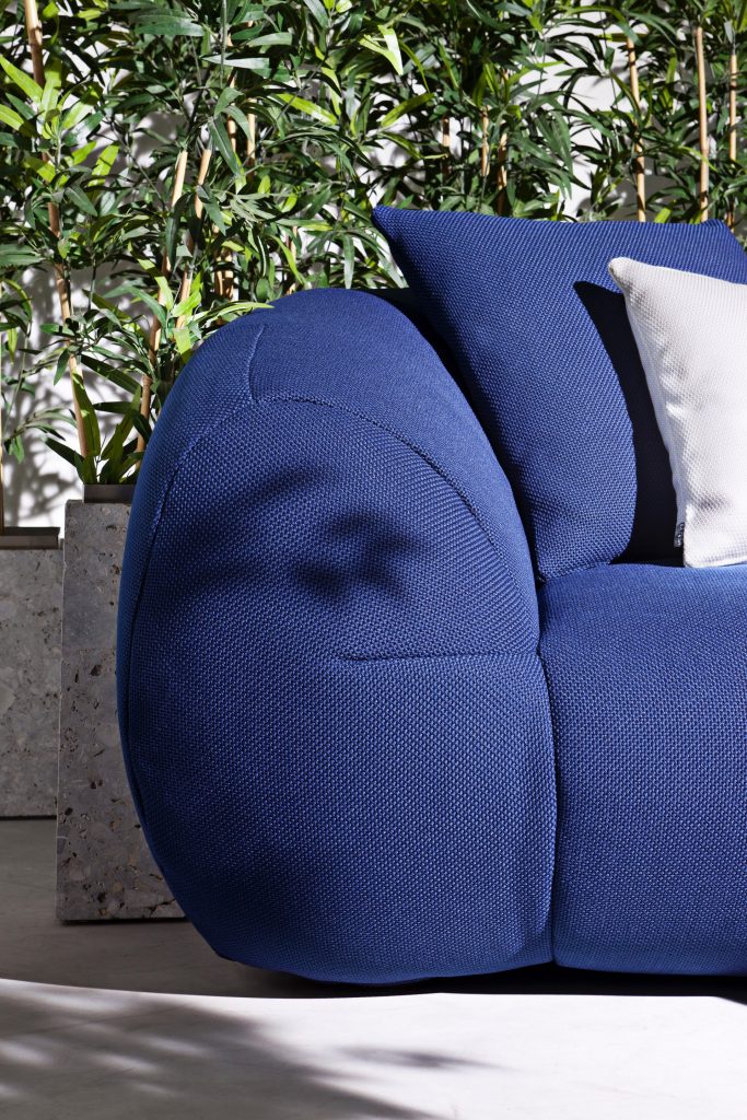 close up of the palau armchair in blue showasing the welt of the armrest