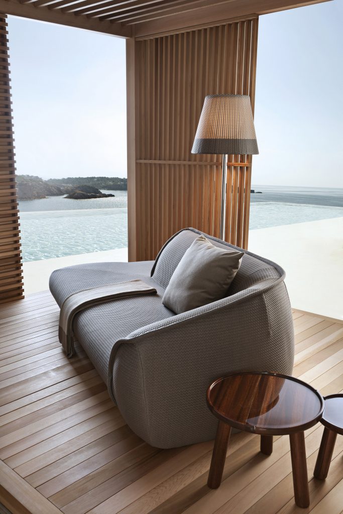 palau daybed in grey fabric inside of an outdoor cabana on a beach