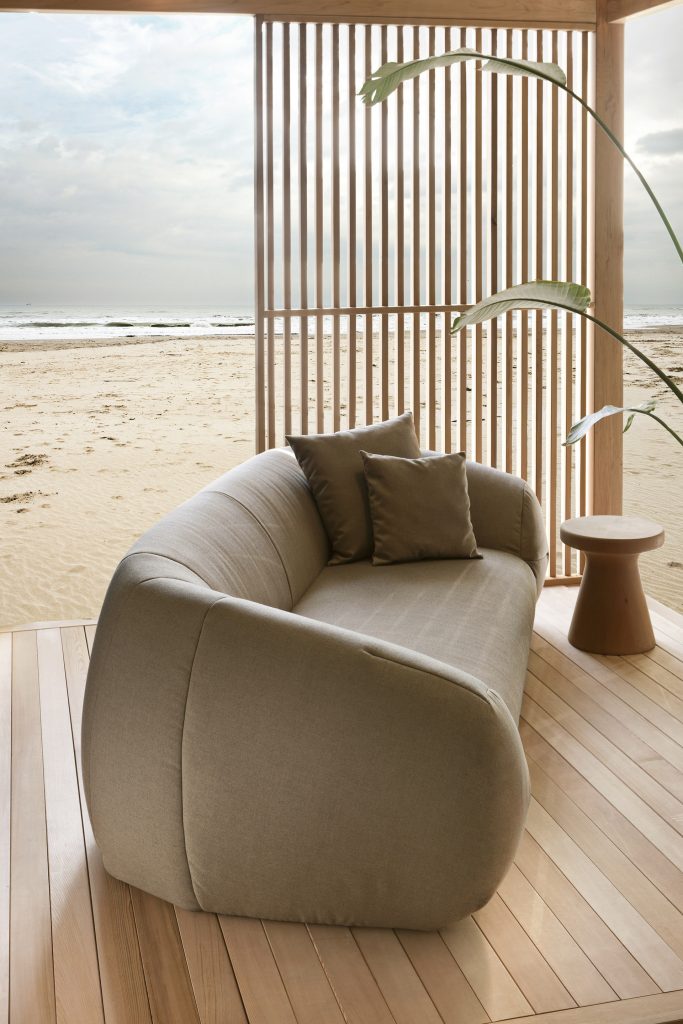 palau outdoor sofa in beige fabric on a beaco n top of a cabana