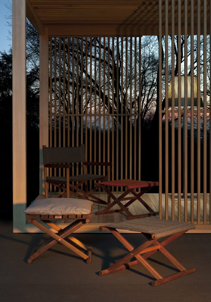 paraggi armchair inside an outdoor cabana in red fabric among other furniture