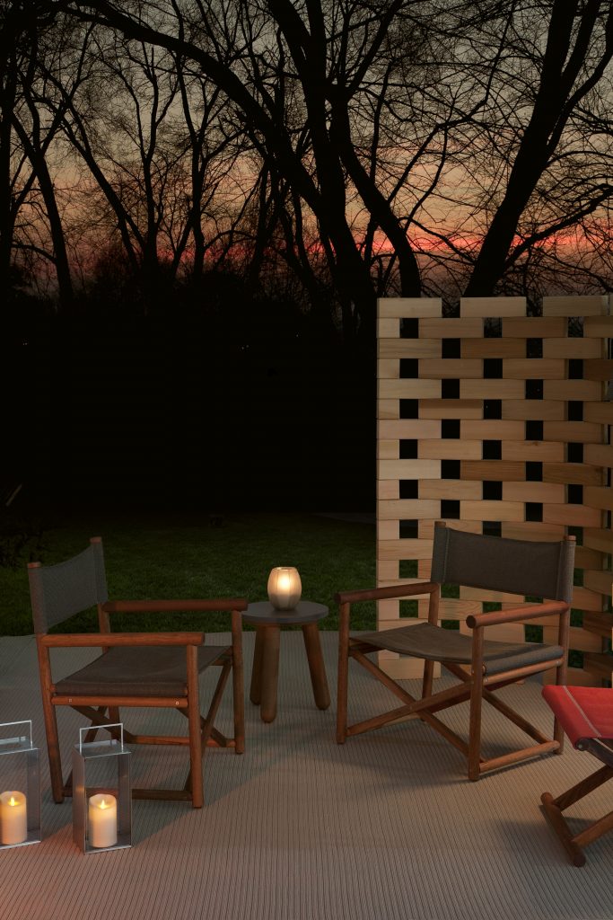 two paraggi armchairs in dark grey color in an outdoor area next to some candles