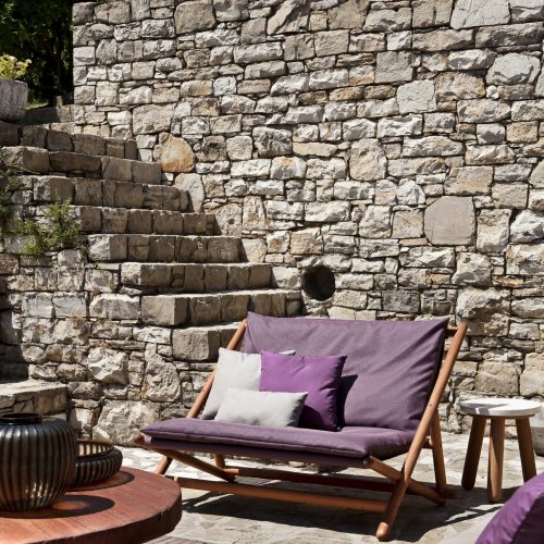 paraggi sofa with purple backrest in an outdoor setting