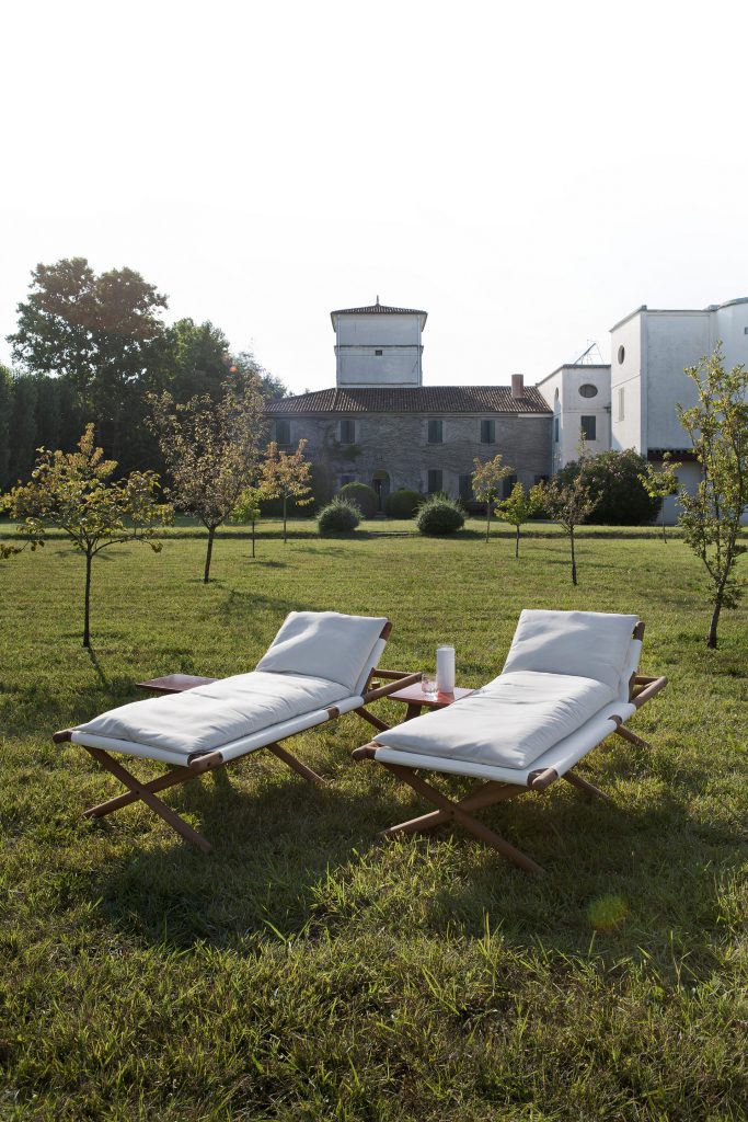 paraggi sun loungers in an open grass area in white