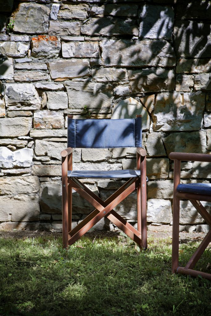blue paraggi yatch chair with stone wall background