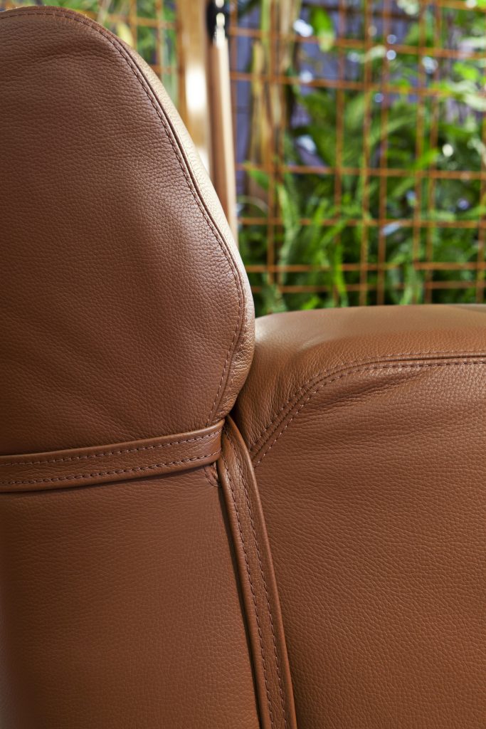 closeup of the stitching of a brown leather soft armchair