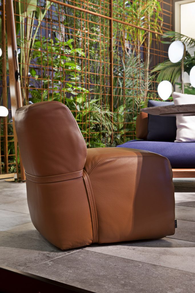 soft armchair in brown leather in a patio area