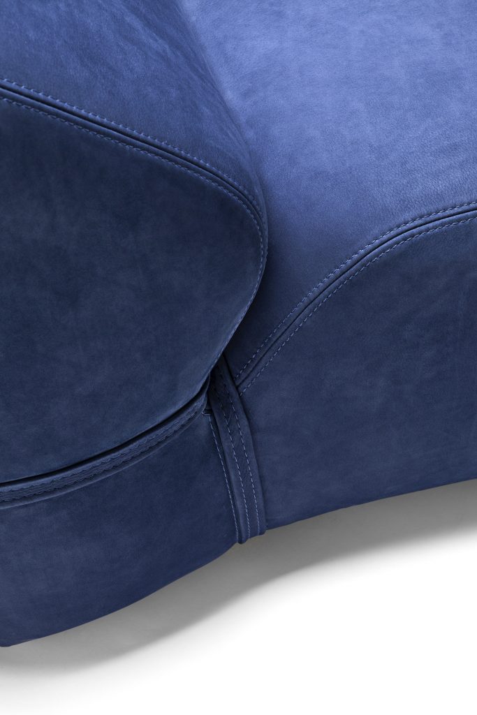 close up of a blue soft chaise lonunge chair