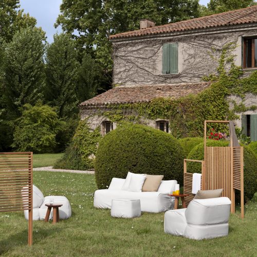 soft sofa in white in an outdoor setting surrounded by furniture