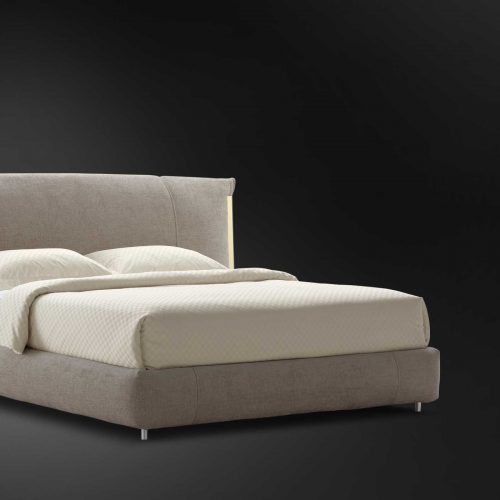 amal bed with beige backrest and white sheets