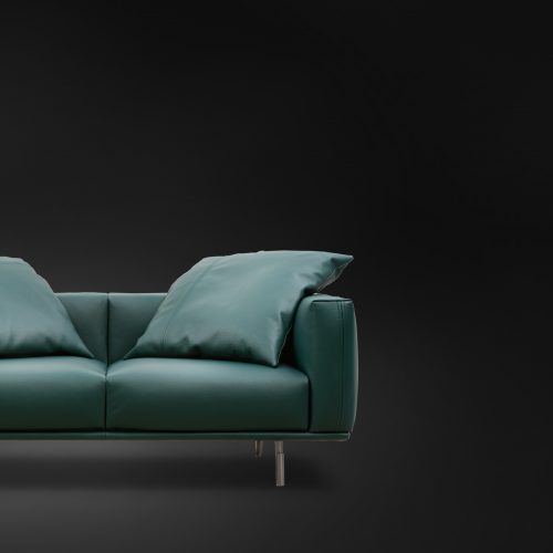 Lineal green Binario Two Seater with backrest, armrest, cushions and silver legs on a black background.