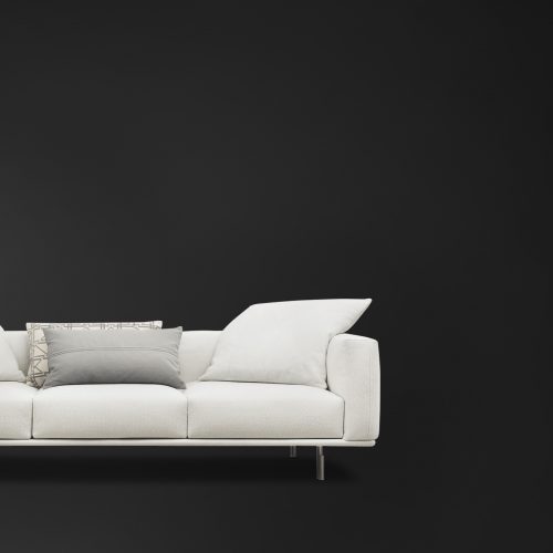 Lineal white Binario three Seater with backrest, armrest, cushions and silver legs on a black background.