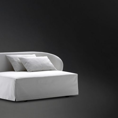 White Celine Sofa Sleeper, bed top, two pillows and wheels on a black background.