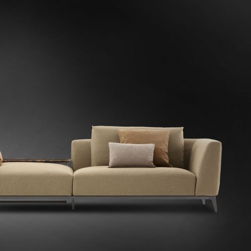 Olivier D sofa upholstered in brown fabric and four legs in steel on a black background.