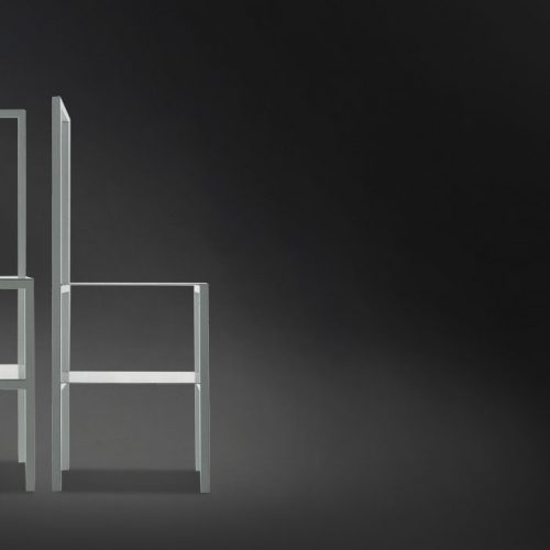 Two white Servomuto with double function chair/coat stand on a black background.