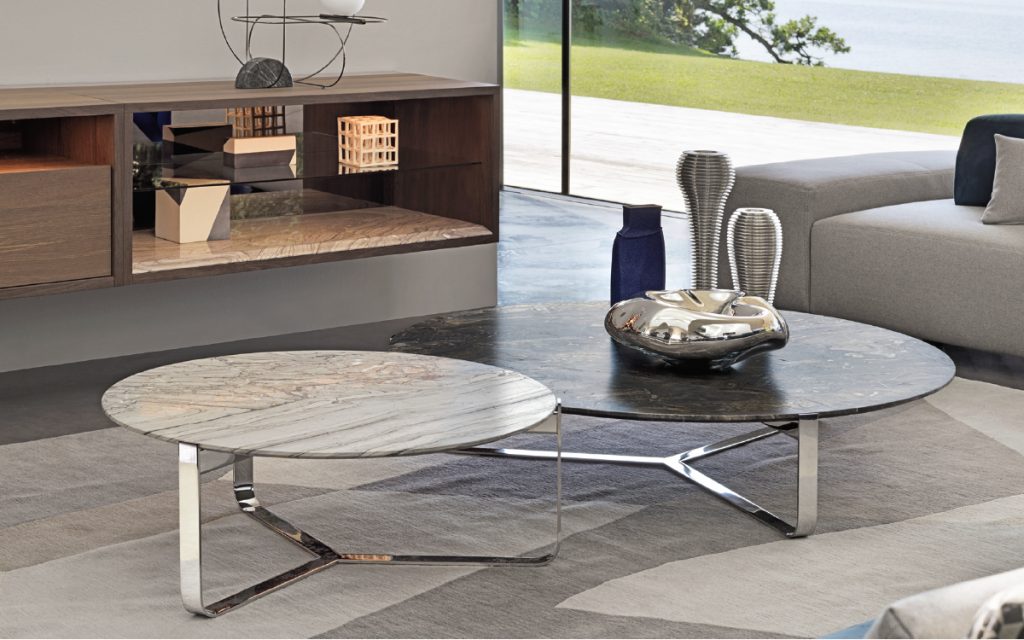 Two round Yari side tables. White and gray, and brown tops. Silver legs in a living room.