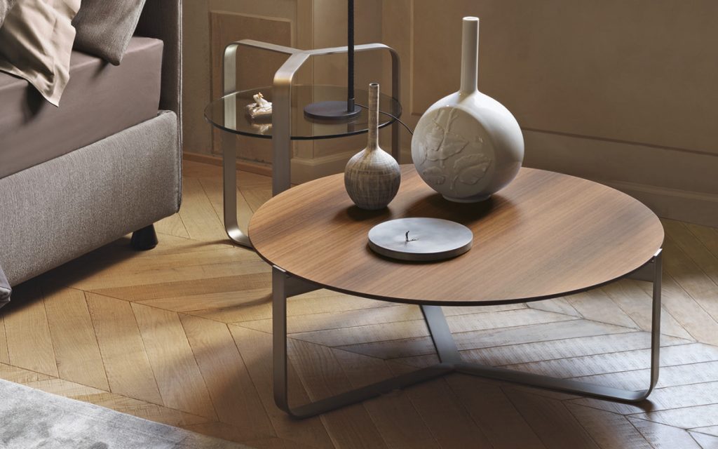 Two Yari round side tables. Brown and glass top and silver legs in a living room.