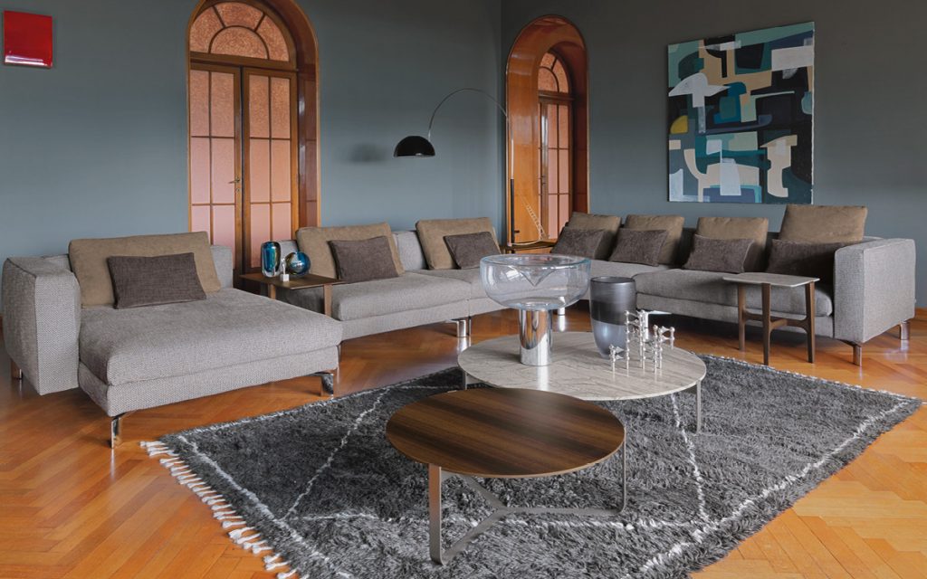 Two Yari round side tables. Brown and gray tops, and silver legs in a living room.