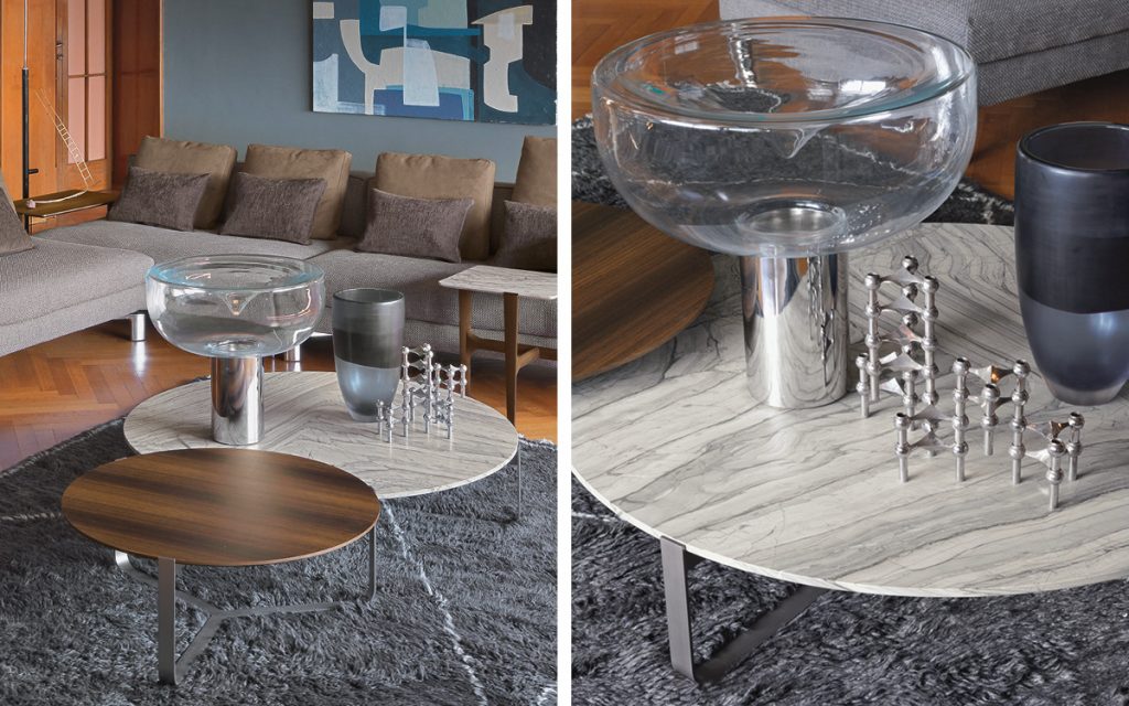 Four Yari round side tables. Brown and gray tops, and silver legs in a living room.