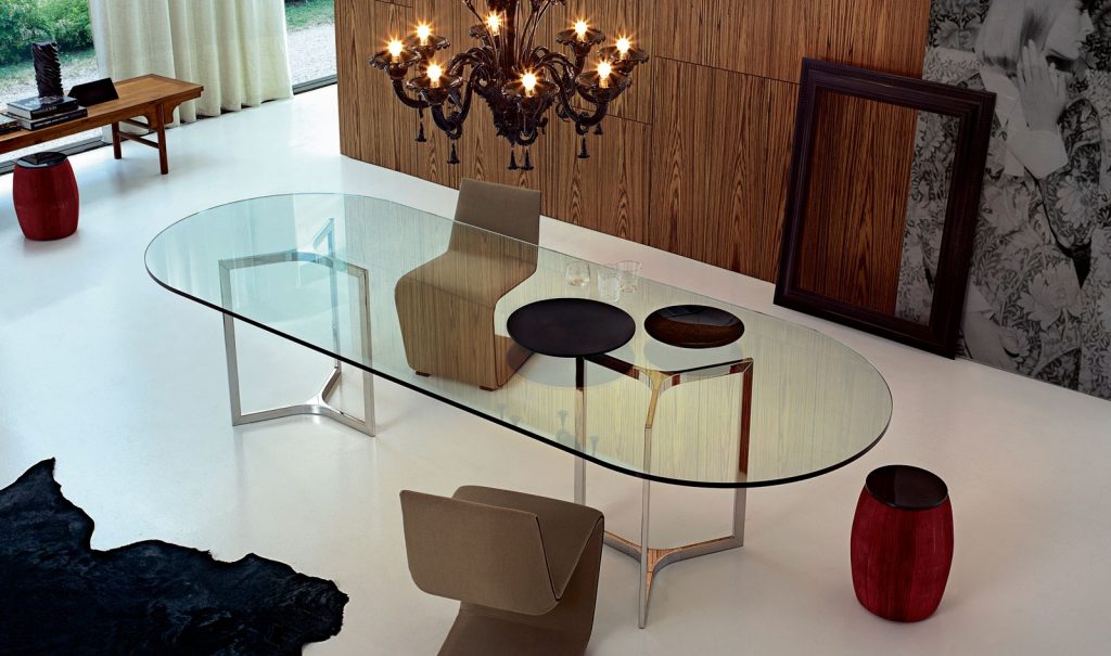 Raj / Raj Light Home: Large oval dining table with a glass top and silver metal frame in an office.