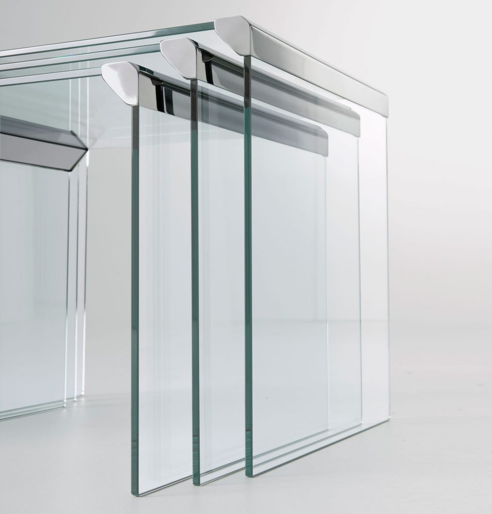 T35Trio: Three clear glass rectangle coffee tables with metal borders on a white background.
