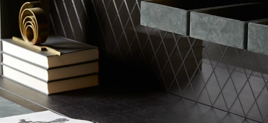 Inside of Tama Crédence: A black wooden console table with storage compartments and gold legs on a white background.